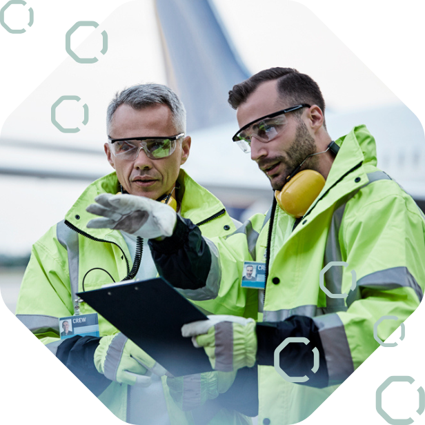 Two airport operations staff planning stand and gate allocation