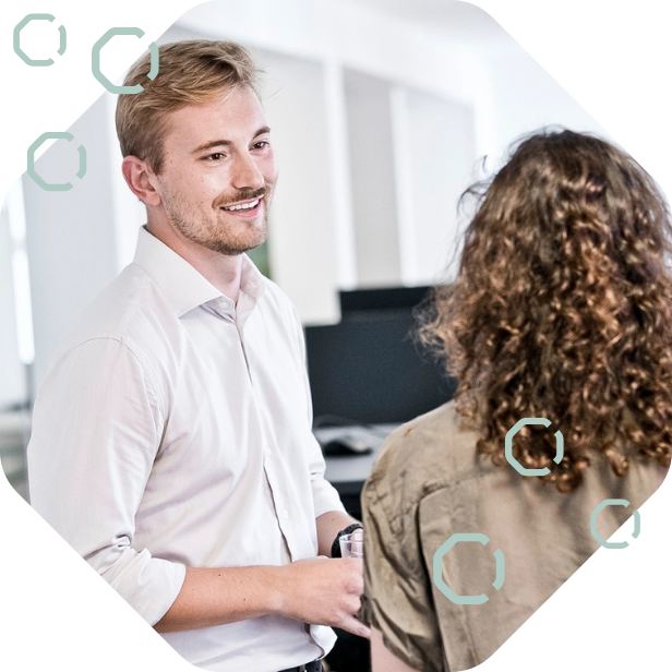 Two co-workers chatting in an office